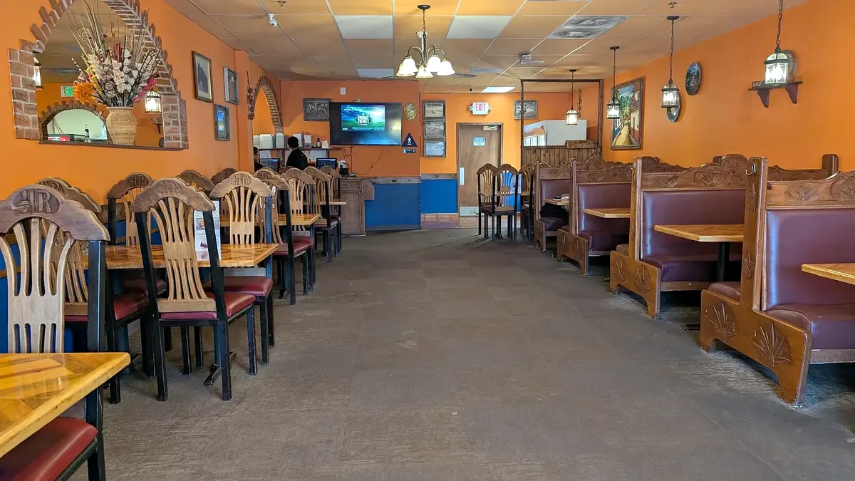 The dining room looking toward the front, carved booths along one wall